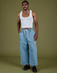 Isaac is 5’10” and wearing M Denim Drop Pocket Pants in Light Wash paired with vintage tee white Cropped Tank