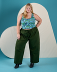 Juliet is wearing Cropped Tank Top in Angel Print and evergreen Drop Pocket Cargo Pants