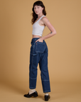Angled back view of Mid-Rise Carpenter Jeans in Dark Wash on Alex