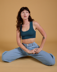 Alex is wearing Mini Tank in Lagoon and light wash Indigo Wide Leg Trousers