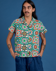 Anthony is wearing a buttoned up Quilt Print Pantry Button-Up