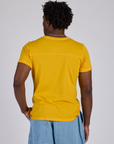 Jr. Varsity Tee in Sunshine Yellow back view on Isaac