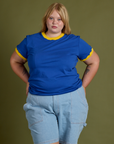 Juliet is 5’7” and wearing L Vintage Ringer Tee in Royal Blue paired with light wash Carpenter Shorts