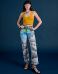 Alex is 5’8” and wearing XXS Work Pants in Night Sky Airbrush paired with mustard yellow Cropped Tank