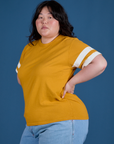 Painted Burly Tee in Mustard Yellow angled front view on Ashley