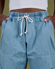 Denim Drop Pocket Pants in Light Wash front close up with Isaac's hand in both pockets