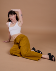 Alex is wearing Drop Pocket Cargo Pants in Spicy Mustard and vintage tee white Cropped Tank