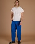 Grant is 6’5” and wearing L Heritage Trousers in Royal Blue paired with vintage off white Organic Vintage Tee