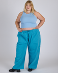 Juliet is 5’7” and wearing 2XL Drop Pocket Cargo Pants in Hawaiian Blue paired with baby blue Racerback Tank
