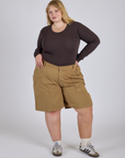 Juliet is 5’7” and wearing 2XL Longline Work Shorts in Desert Brown paired with espresso brown Long Sleeve Baby Tee