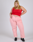 Juliet is 5’7” and wearing 2XL Work Pants in Baby Pink paired with mustang red Cropped Tank