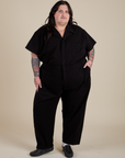 Sam is 5'10" and wearing 4XL Short Sleeve Jumpsuit in Basic Black