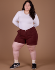 Ashley is 5’7” and wearing 1XL Classic Work Shorts in Red Wine paired with vintage tee white Long Sleeve Baby Tee