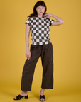 Alex is wearing Checker Organic Tee in Espresso Brown and Drop Pocket Cargo Pants in Espresso Brown