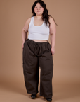 Ashley is 5'7" and wearing 1XL Drop Pocket Cargo Pants in Espresso Brown paired with a vintage tee white Cropped Tank