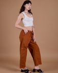 Side view of Drop Pocket Cargo Pants in Burnt Terracotta and vintage tee white Cropped Tank