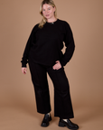 Lish is wearing Long Sleeve Burly Tee in Basic Black paired with black Western Pants
