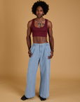 Jerrod is wearing Mini Tank in Red Wine and light wash Indigo Wide Leg Trousers