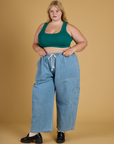 Juliet is wearing Contrast Stitch Mini Tank in Hunter Green paired with light wash Denim Drop Pocket Pants