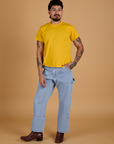 Jesse is wearing Organic Vintage Tee in Sunshine Yellow and light wash Carpenter Jeans