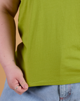 Organic Vintage Tee in Gross Green bottom close up with Ashley holding hem