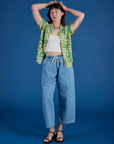 Alex is wearing Spring Quilt Print Pantry Button-Up paired with light wash Denim Drop Pocket Pants