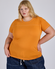 Juliet is 5’7” and wearing L Jr. Varsity Tee in Creamsicle Orange