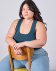 Ashley is wearing Cropped Tank Top in Lagoon and sitting in a chair