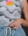 Hem Close up of the Dark Cloud Airbrush Muscle Tee worn by Alex