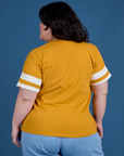 Painted Burly Tee in Mustard Yellow back view on Ashley