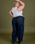 Angled Back view of Denim Drop Pocket Pants in Dark Wash and Cropped Tank in Vintage Tee White on Juliet