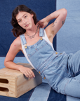 Alex is wearing Indigo Denim Original Overalls in Light Wash