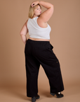 Angled back view of Drop Pocket Cargo Pants in Basic Black and Cropped Tank in vintage tee white on Juliet