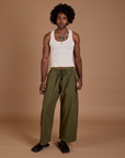 Jerrod is 6’3” and wearing M Drop Pocket Cargo Pants in Surplus Green paired with a Tank Top in vintage tee white