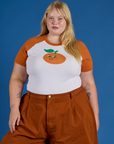Juliet is 5’7” and wearing L Produce Raglan Tee in Orange