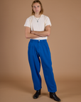Grant is wearing Heritage Trousers in Royal Blue with a tucked in Organic Vintage Tee in Vintage Off White