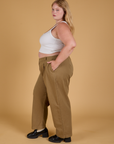 Side view of Baggy Mid-Rise Trousers in Desert Brown and vintage tee white Cropped Tank on Juliet