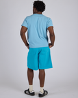 Back view of Longline Work Shorts in Hawaiian Blue and baby blue Organic Vintage Tee on Isaac