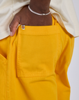Close up of Isaac's hand in the back pocket of Longline Work Shorts in Sunshine Yellow