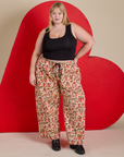 Juliet is 5’7” and wearing 1XL Hot Stuff Drop Pocket Cargo Pants paired with a black Cropped Tank