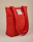 Angled view of Over-Shoulder Zip Mini Tote in Mustang Red