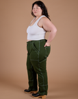 Side view of Carpenter Jeans in Evergreen and Cropped Tank in Vintage Tee White on Ashley