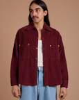 Anthony is 5'6" and wearing S Cropped Corduroy Overshirt in Red Wine