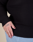 Long Sleeve Baby Tee in Basic Black bottom close up on Sam