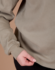 Long Sleeve Burly Tee in Khaki Grey bottom close up with Lish holding the hem