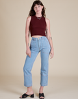 Alex is wearing Muscle Tee in Red Wineand light wash Carpenter Jeans