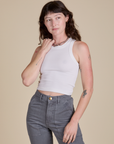 Alex is 5’8” and wearing P Racerback Tank in Vintage Tee White