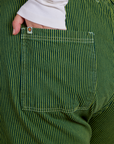 Close up of Juliet's hand in the back pocket of Railroad Denim Work Pants in Gross Green Overdye