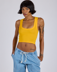Kira is 5’10” and wearing P Cropped Tank Top in Sunshine Yellow