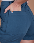 Close up of Alex's hand in the back pocket of Classic Work Shorts in French Blue